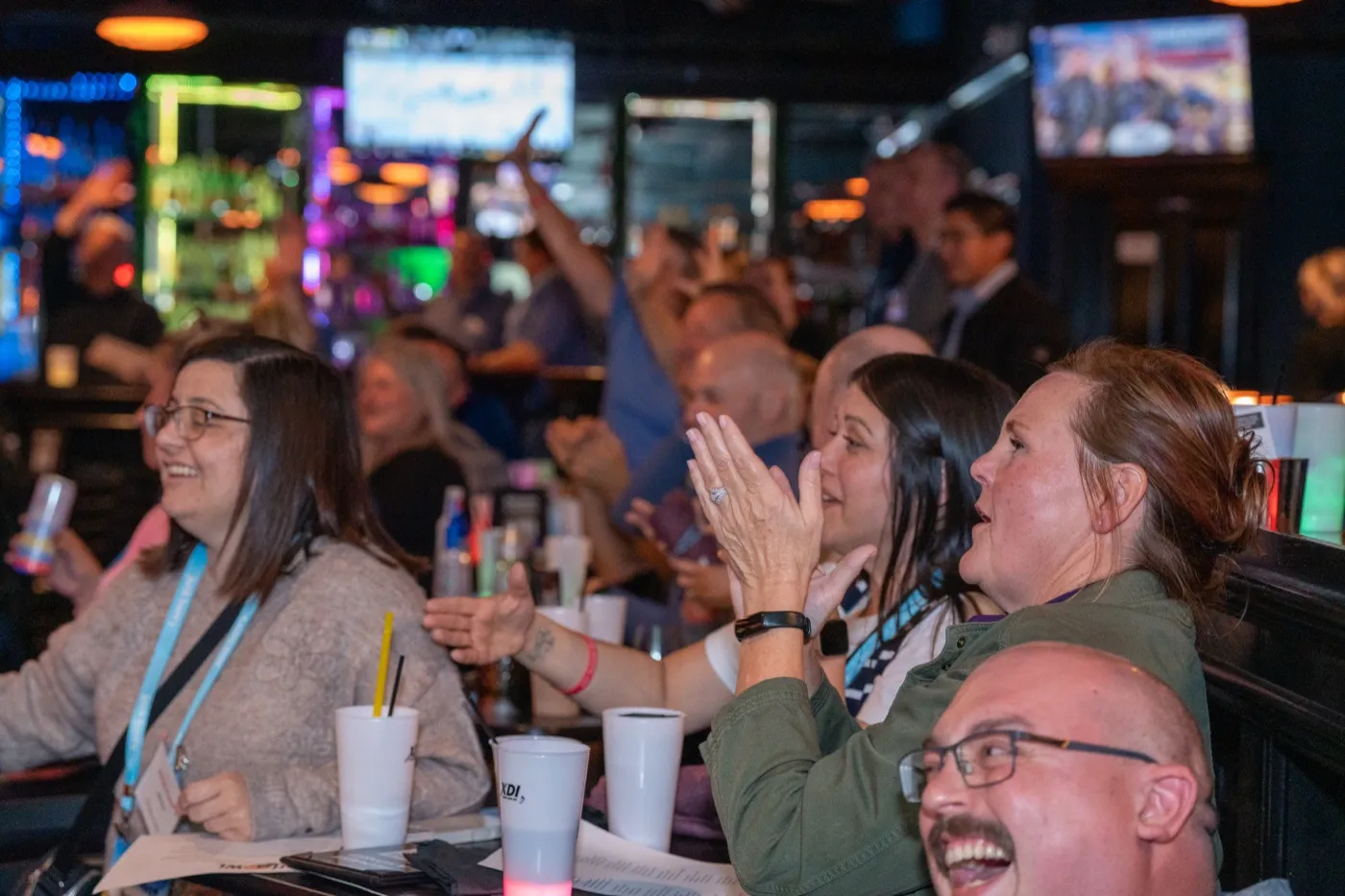 Kansas City corporate event photography - guests laughing and cheering during the dueling piano show