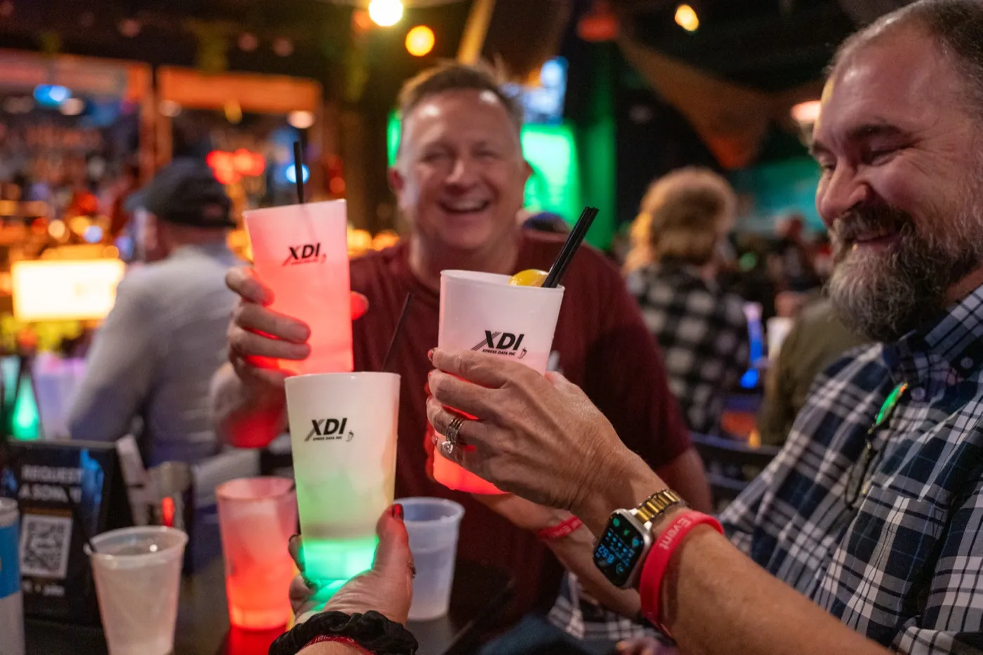 Kansas City corporate event photography - guests toasting with glowing branded cups