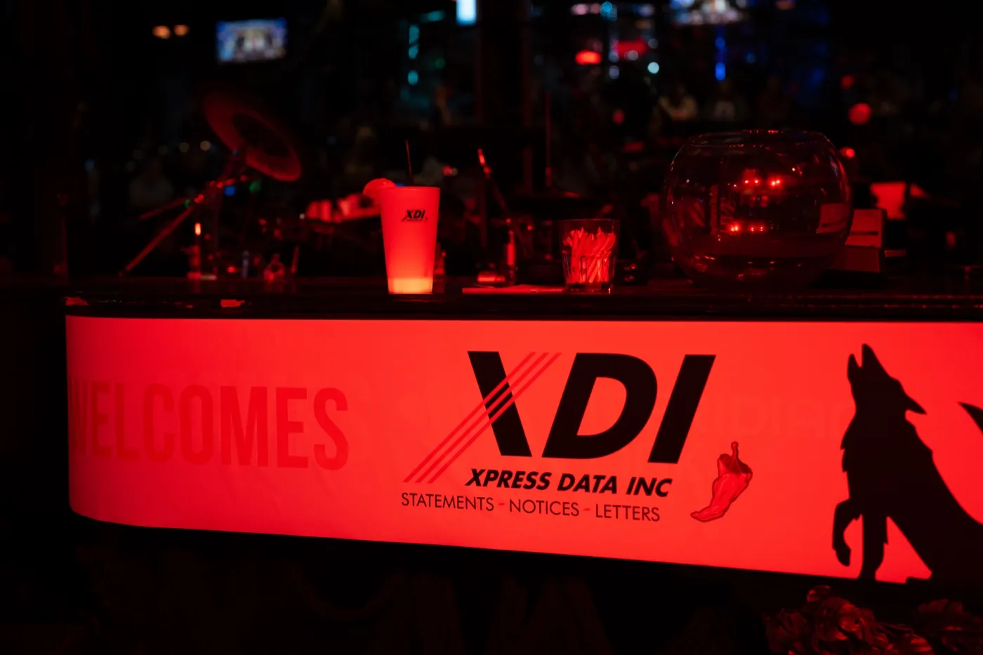 Kansas City corporate event photography - company welcome banner lit up on the piano stage