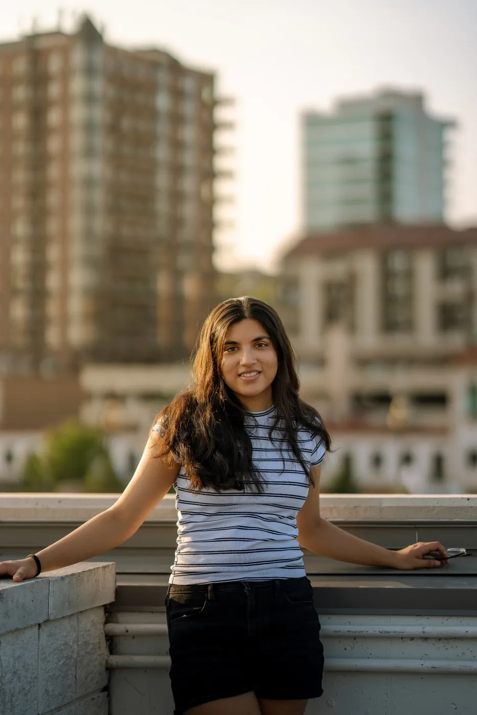 Kansas City portrait photographer - rooftop portrait against the Kansas City skyline at golden hour